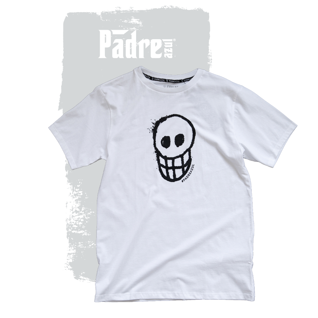 The Padre Azul T-shirt white on a grey background. In the middle of the shirt is a black skull.